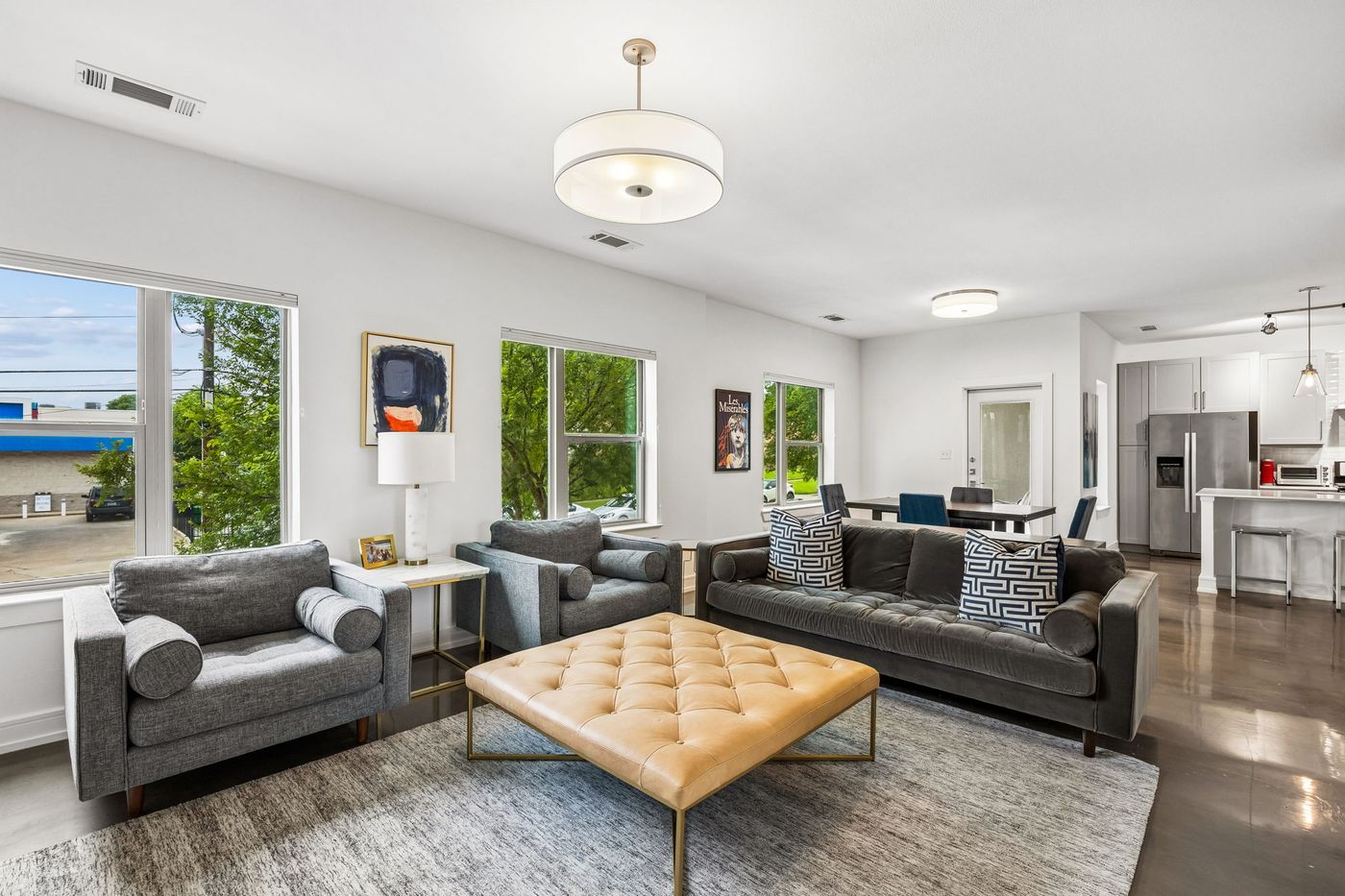 Open living room at 5710 McCommas Blvd Unit 101, looking through to the dining area and kitchen beyond.